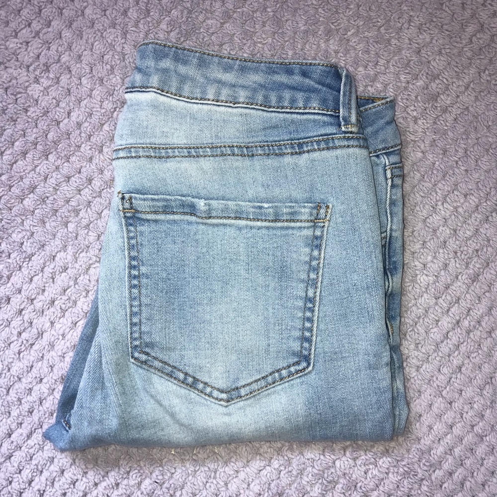 Light Blue Jeans with frayed bottoms